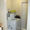 The laundry room includes a full-size washer